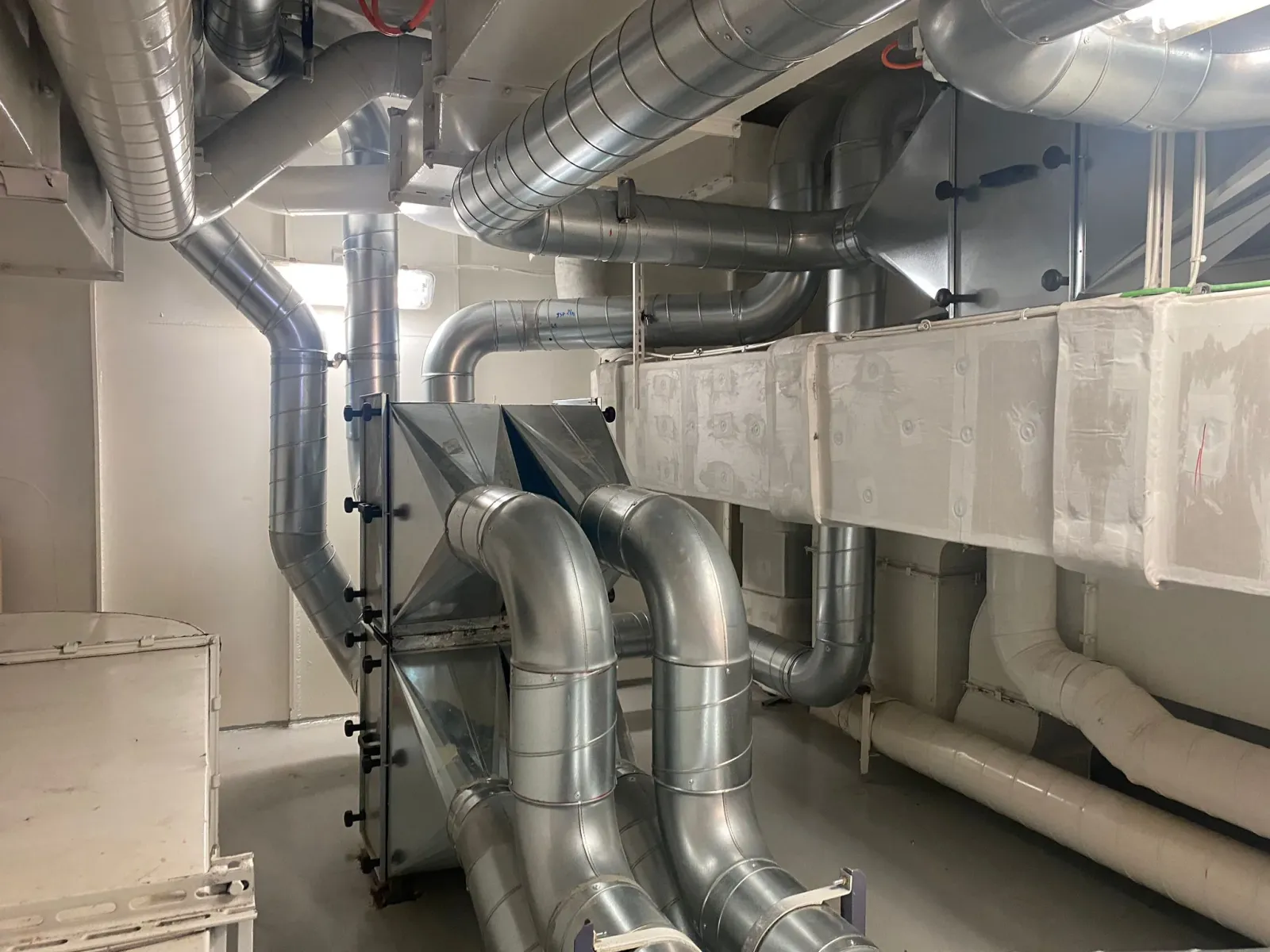 Ventilation ductwork and piping installation in a technical room